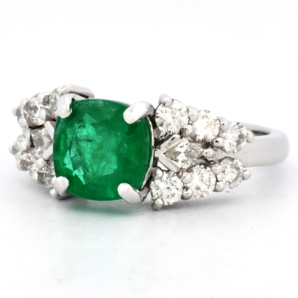 Green gemstone ring with surrounding diamonds from an A&B auction