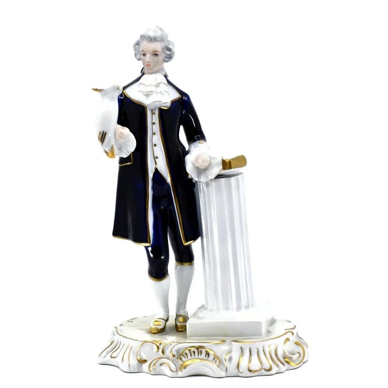 Porcelain gentleman figure with navy clothing and gold accents